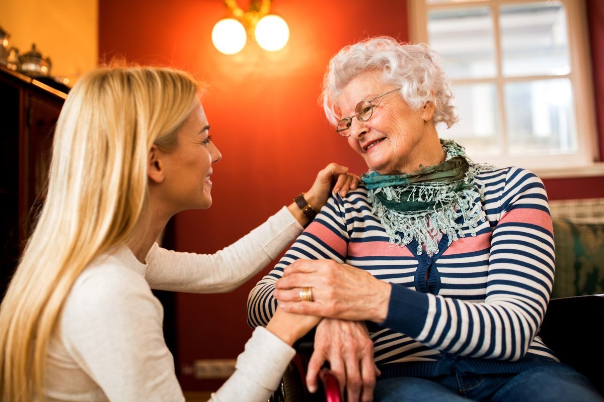 A caregiver comforting an older adult